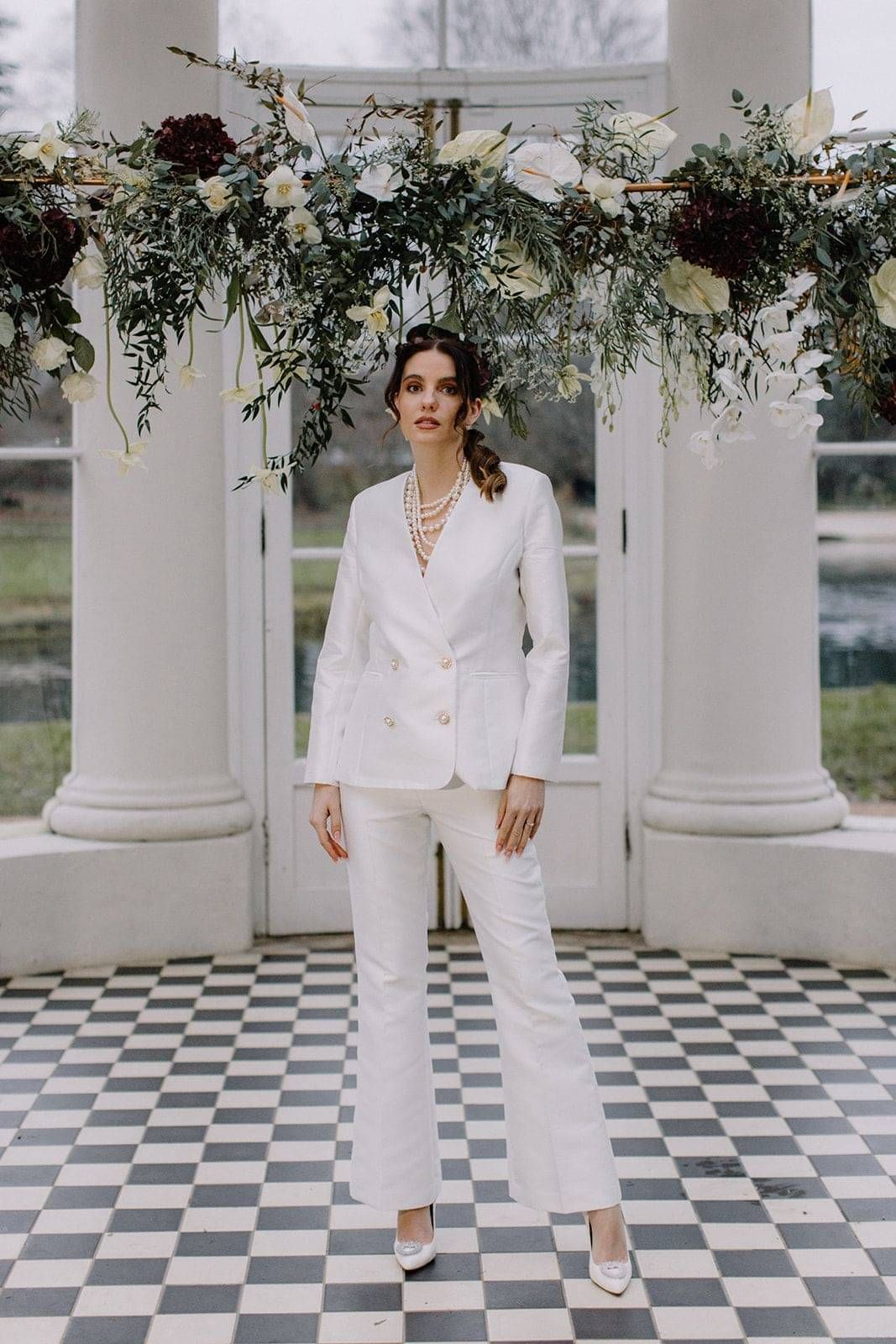 Bride wearing a bespoke white tailored bridal suit, double breasted and tapered trouser, for a civil ceremony wedding