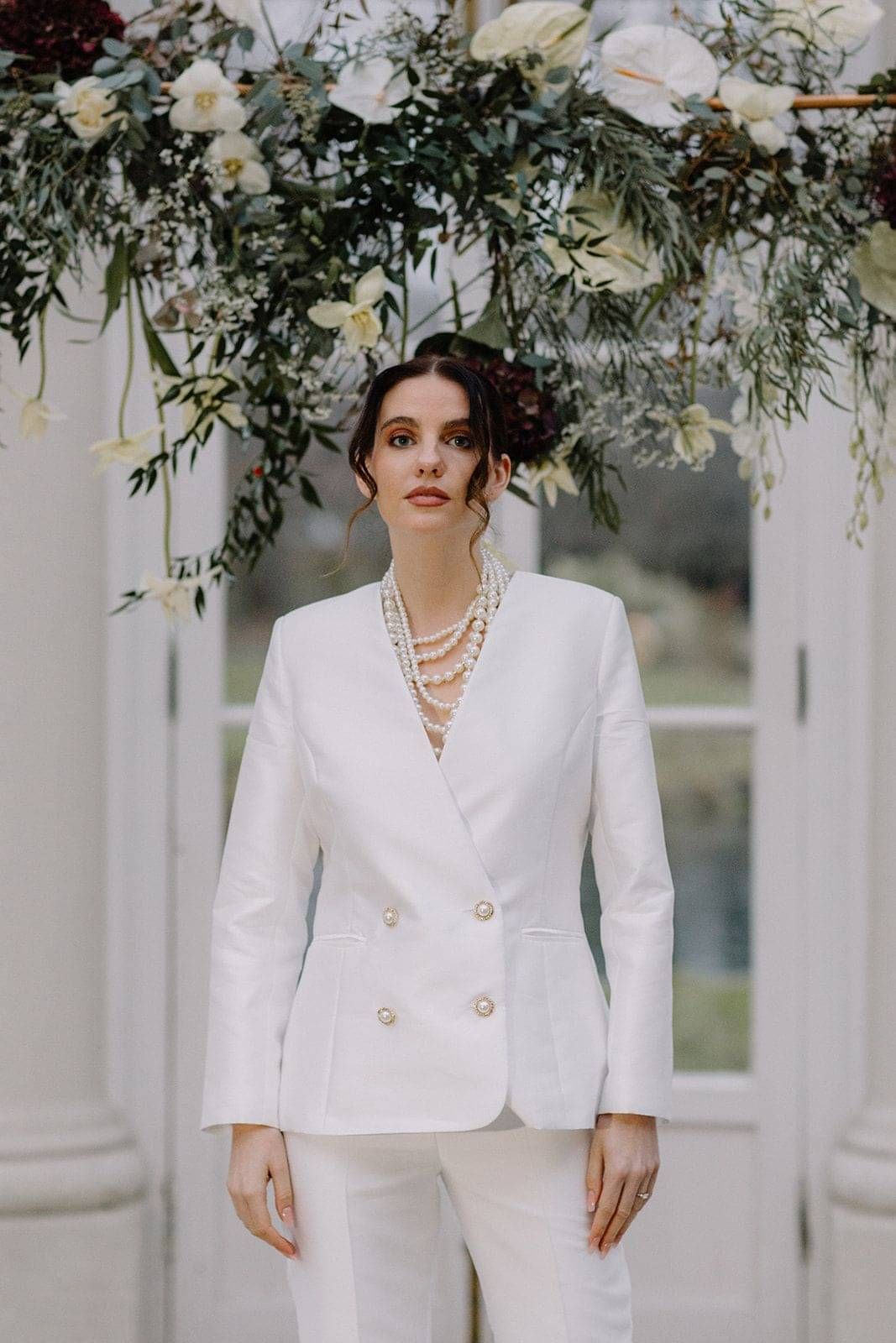 Bride wearing double breasted suit jacket with pearl buttons, Wedding suits for the bride, designer bridal suits, London,