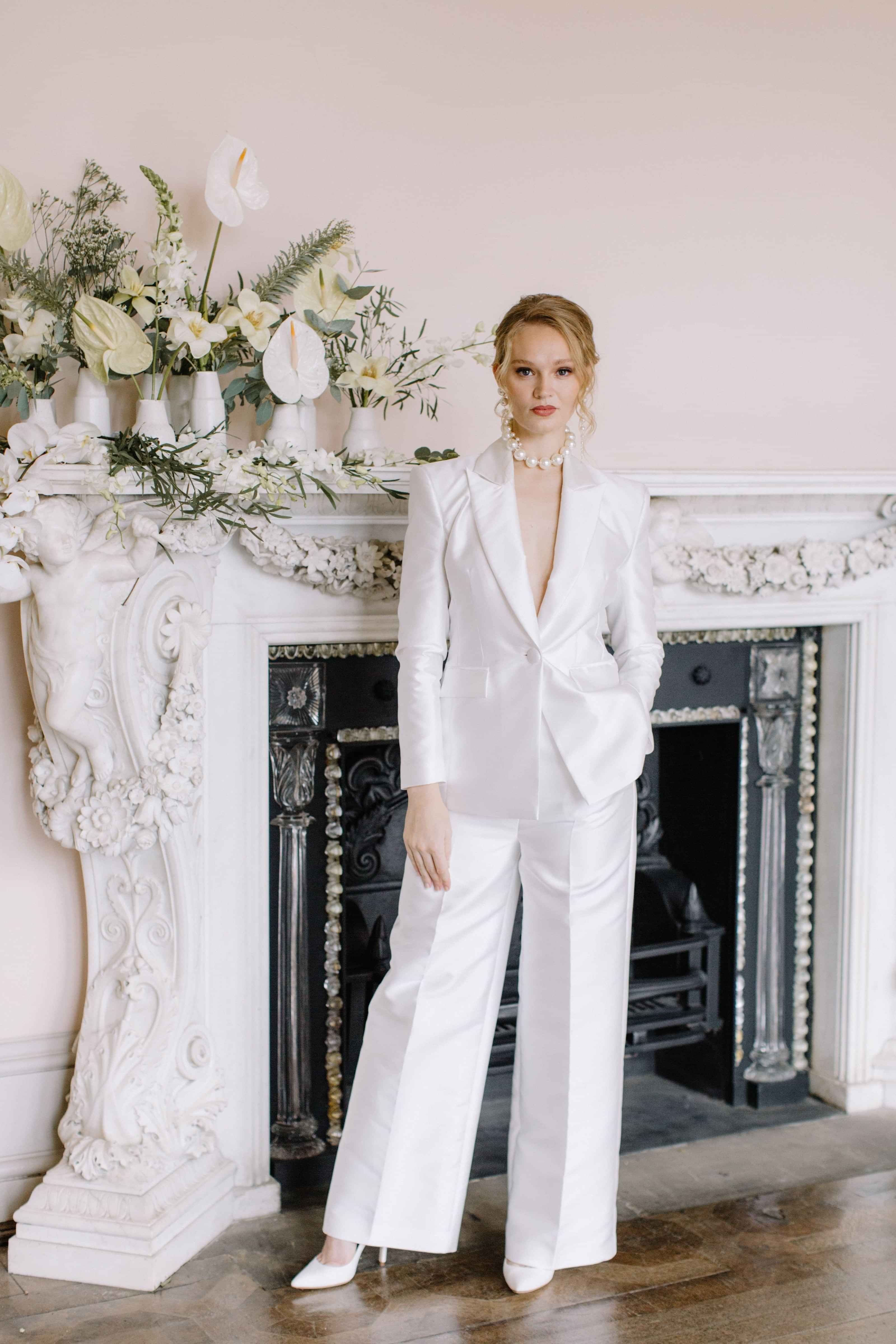 Modern bride wearing tailored ivory bridal trouser suit, by Kate Edmondson