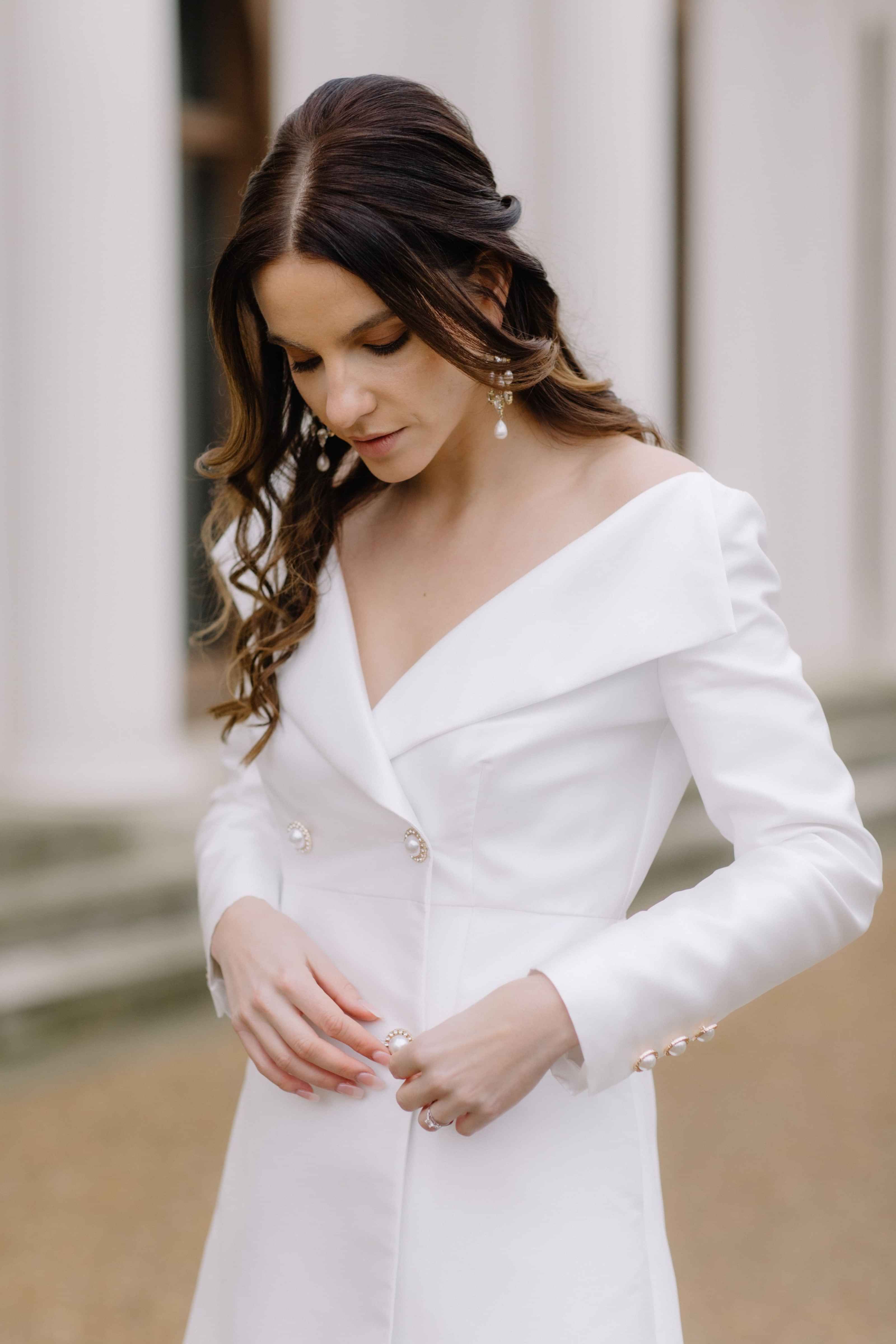 Bride fastening buttons on her short bridal blazer coat dress, Civil wedding dress, Elopement wedding dress, bridal outfit