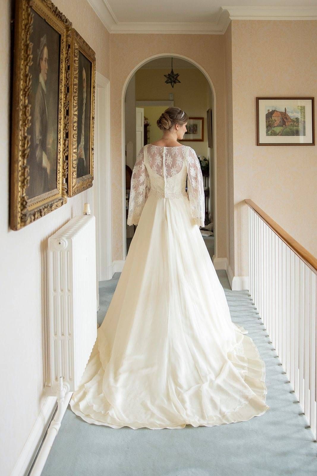 Back profile of bride wearing bespoke wedding dress and bridal top custom made by Kate Edmondson
