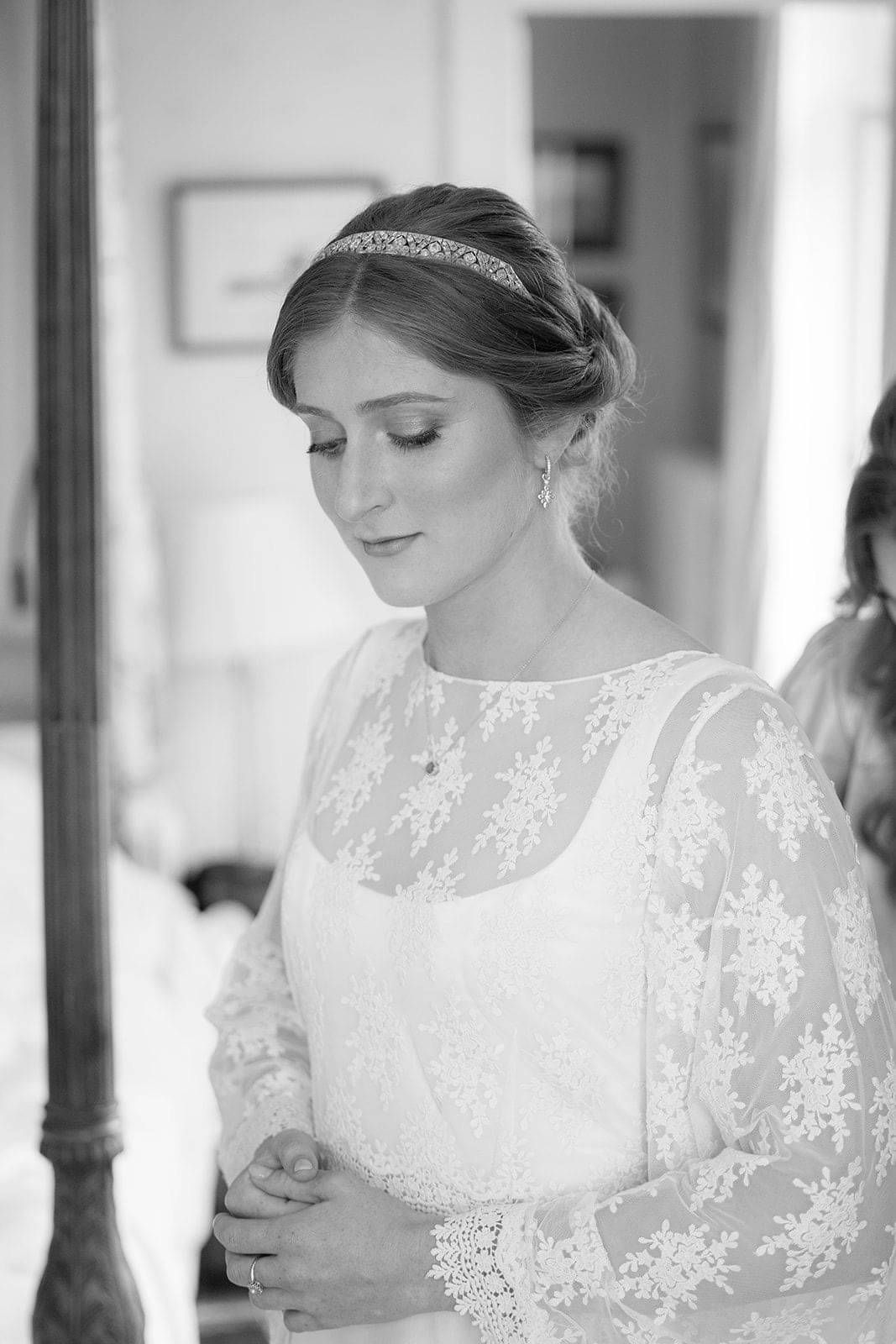 Bride getting ready on her wedding day wearing a bespoke wedding gown and lace bridal top by Kate Edmondson