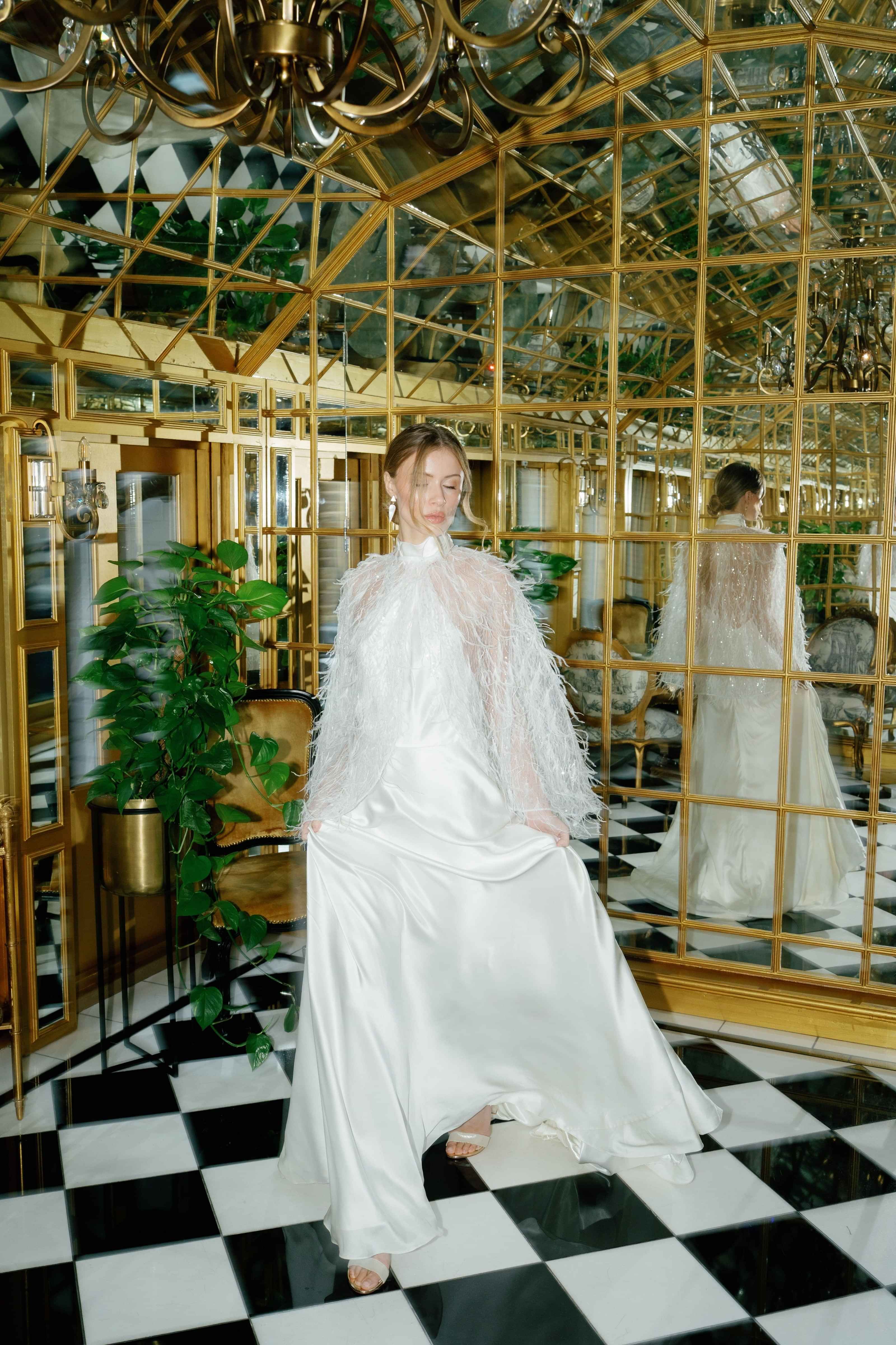 Luxury halter neck wedding dress with feathered cape, by Kate Edmondson