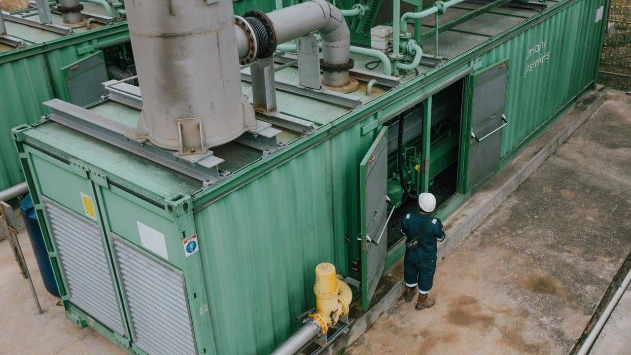 Engineer inspecting a containerised biogas unit at a GREE Energy plant in Indonesia.