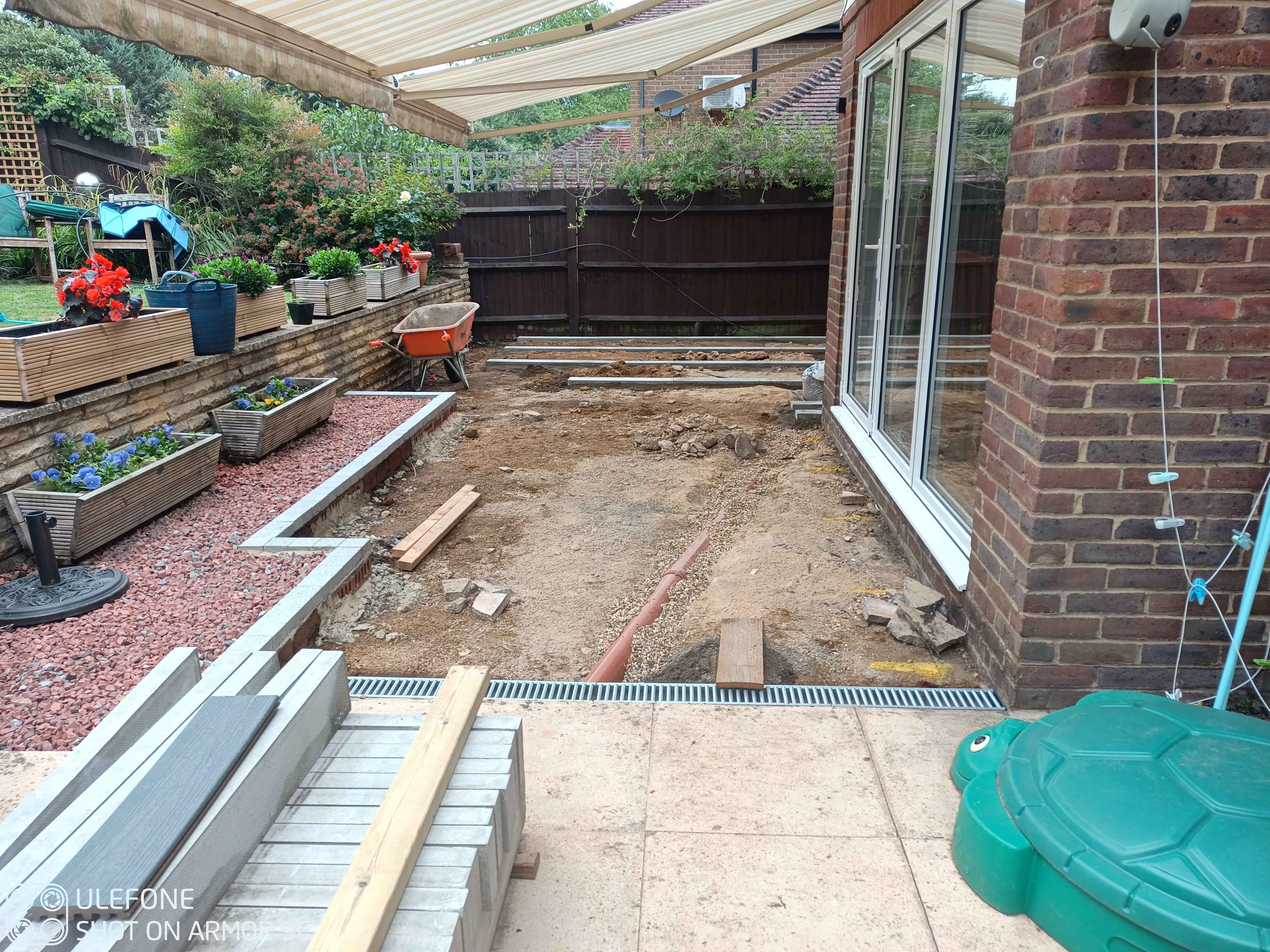 Image shows the drainage pipe running across the base which will be under the decking.