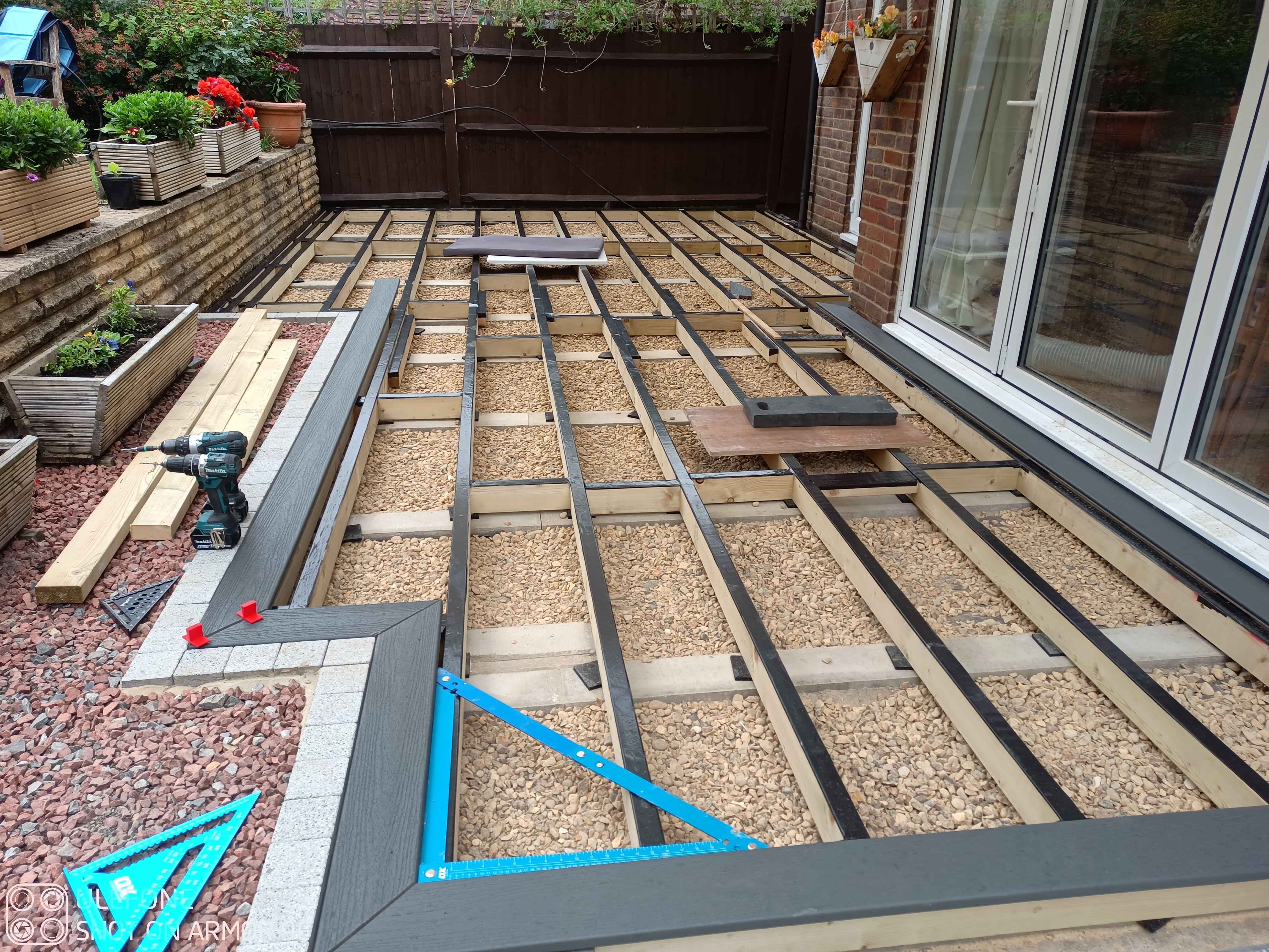 This image shows the decking tape in place and the first few outside frame deck boards being fitted.