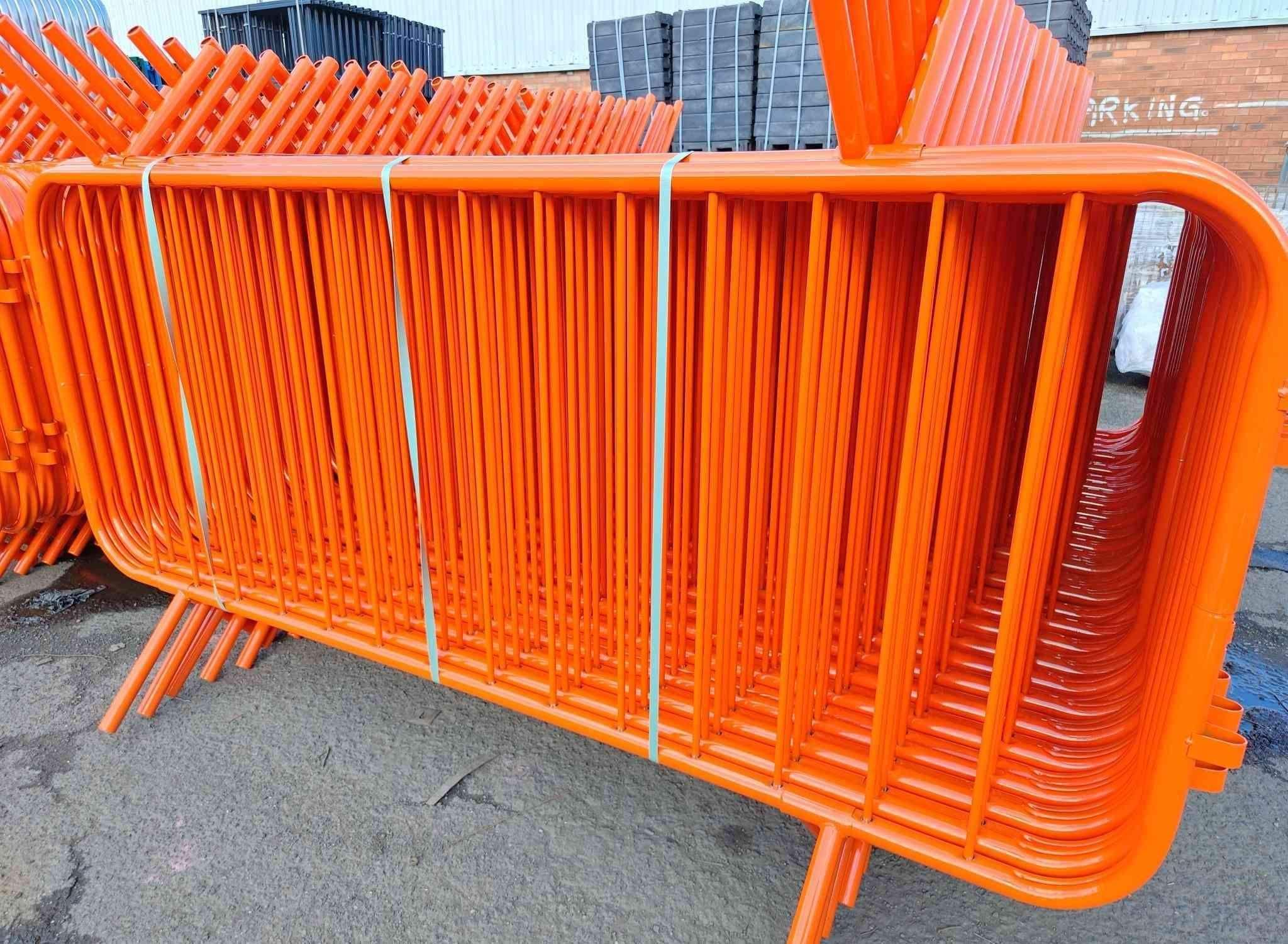 Orange powder coated crowd barrier – high-visibility RAL colour finish for traffic management and festivals.
