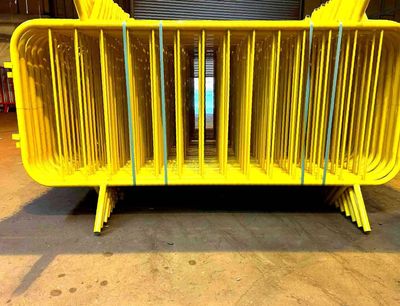Powder-coated yellow crowd control barriers — TempFence UK